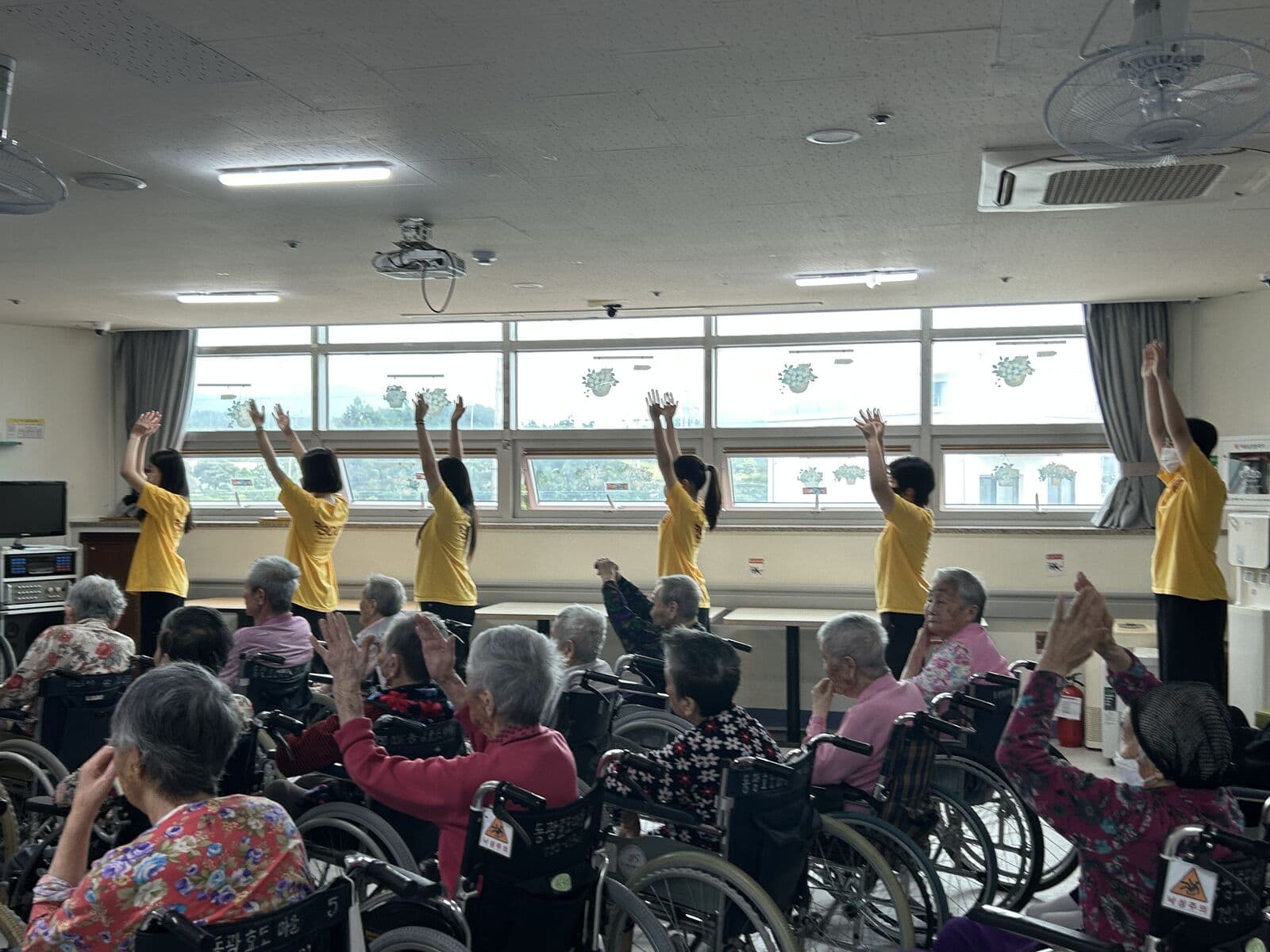 Jeju chapter members leading an activity at a senior care center